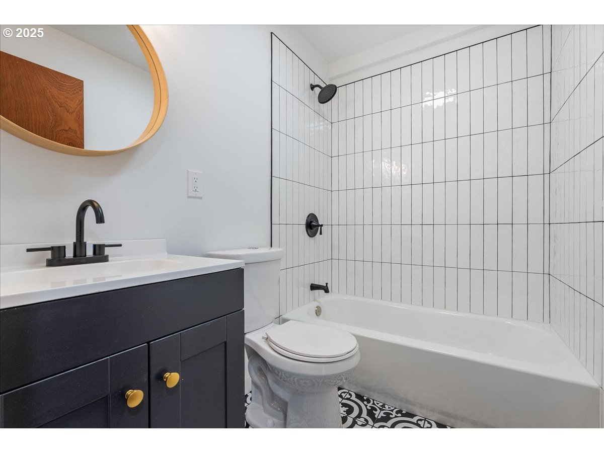 8951 Southeast Fuller Road, Unit 36 Happy Valley, OR 97086 - Photo 15 of 27 a bathroom with a sink a toilet and shower