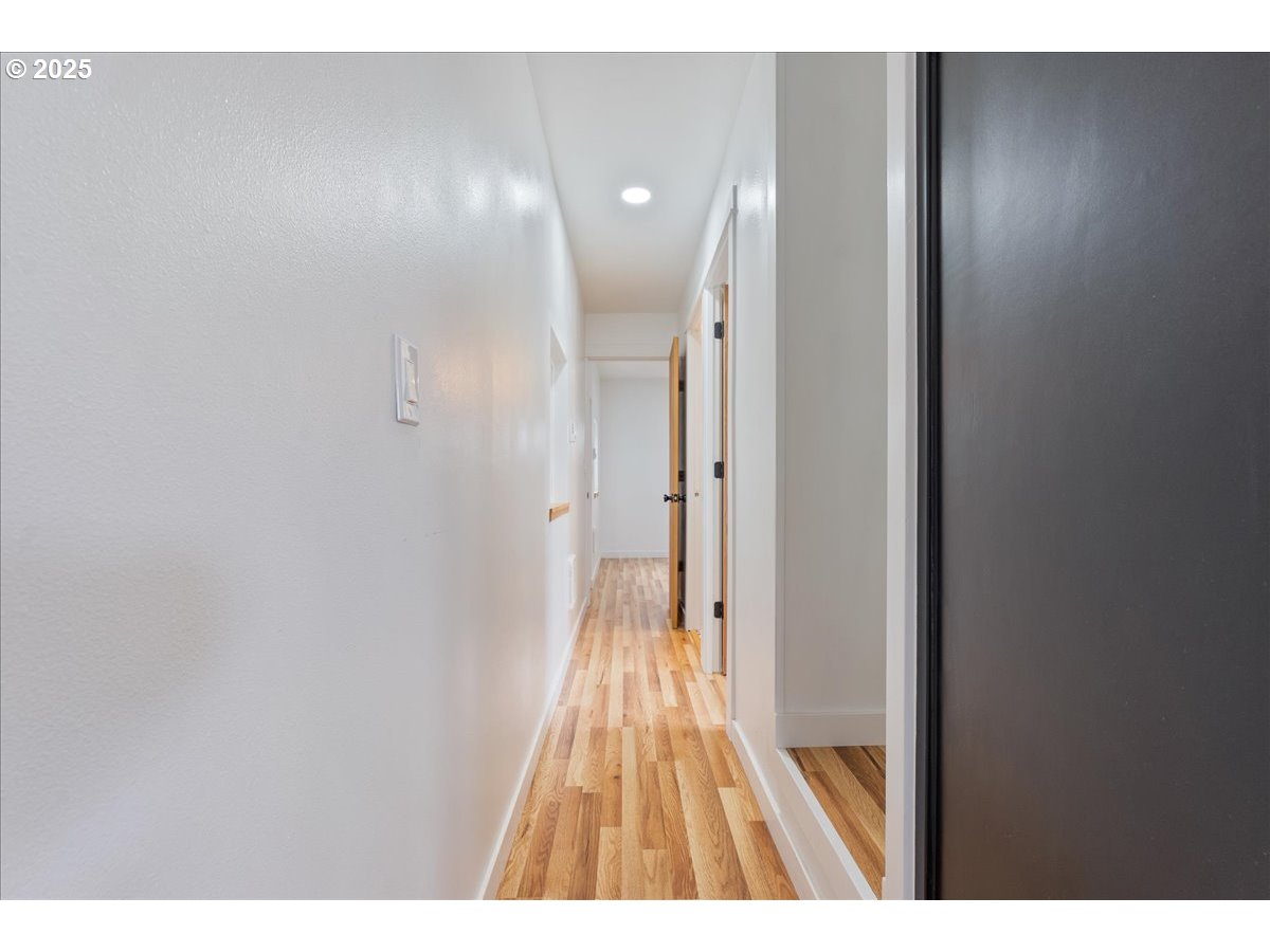 8951 Southeast Fuller Road, Unit 36 Happy Valley, OR 97086 - Photo 16 of 27 a view of a hallway with wooden floor