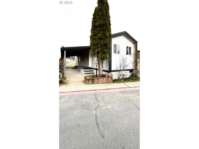 a view of residential house with swimming pool and sitting area
