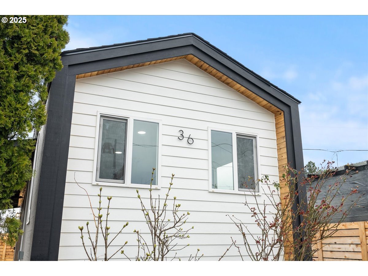 8951 Southeast Fuller Road, Unit 36 Happy Valley, OR 97086 - Photo 4 of 27 a view of a house with a yard
