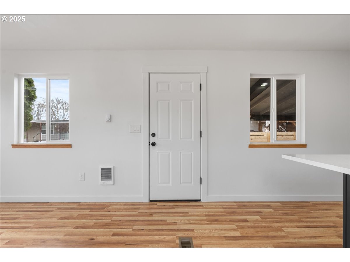 8951 Southeast Fuller Road, Unit 36 Happy Valley, OR 97086 - Photo 6 of 27 a view of an empty room with window and wooden floor