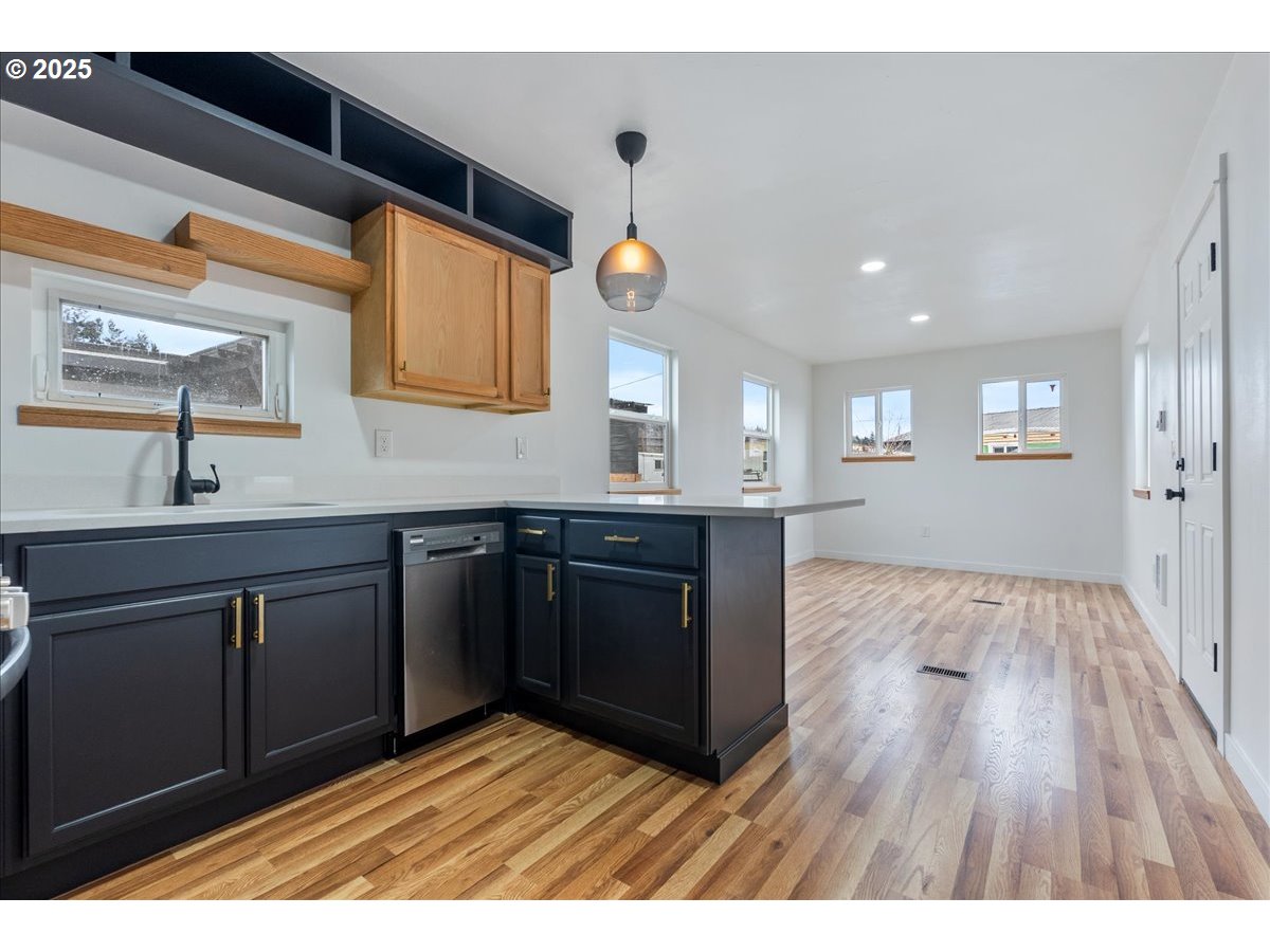 8951 Southeast Fuller Road, Unit 36 Happy Valley, OR 97086 - Photo 8 of 27 a kitchen with a sink and wooden floor