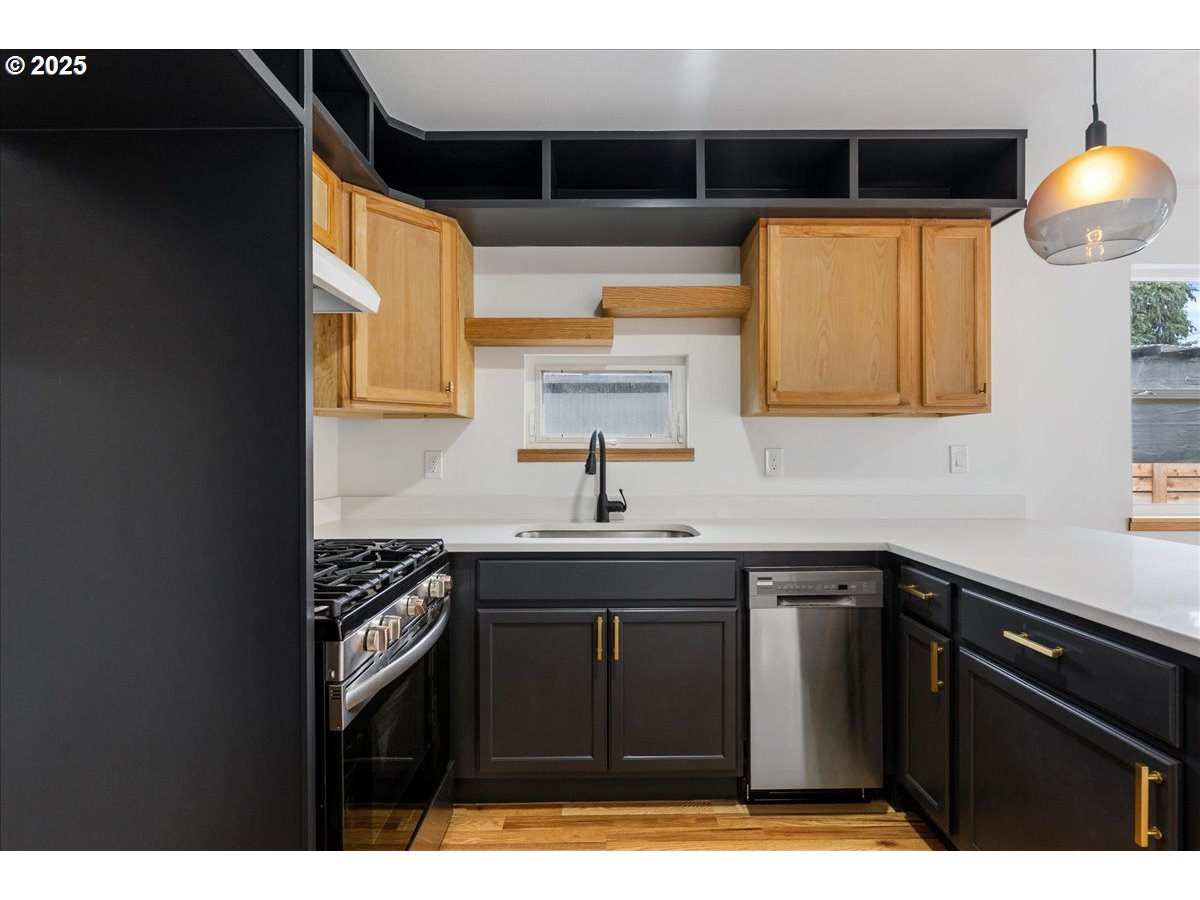 8951 Southeast Fuller Road, Unit 36 Happy Valley, OR 97086 - Photo 10 of 27 a kitchen with a sink a stove and cabinets