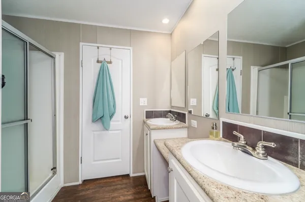 a bathroom with double vanity sink and a mirror