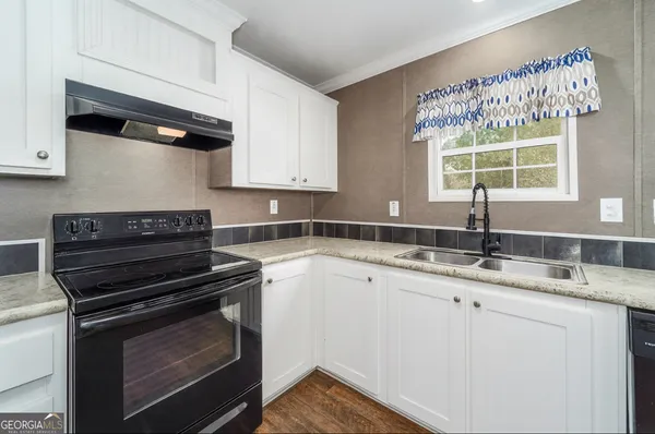 a kitchen with a sink stove and microwave