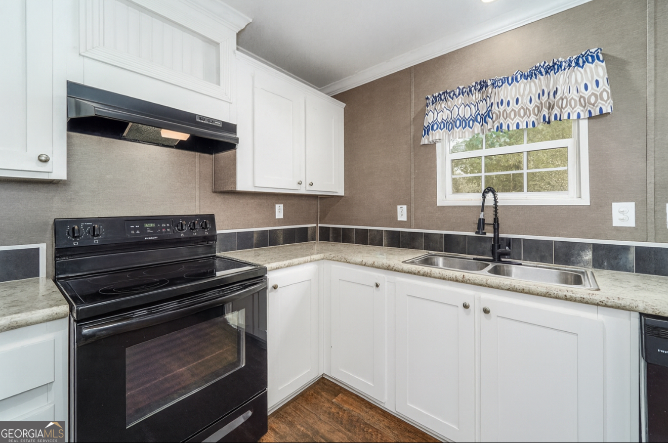 6911 Old Hortense Road Hortense, GA 31543 - Photo 13 of 19 a kitchen with a sink stove and microwave