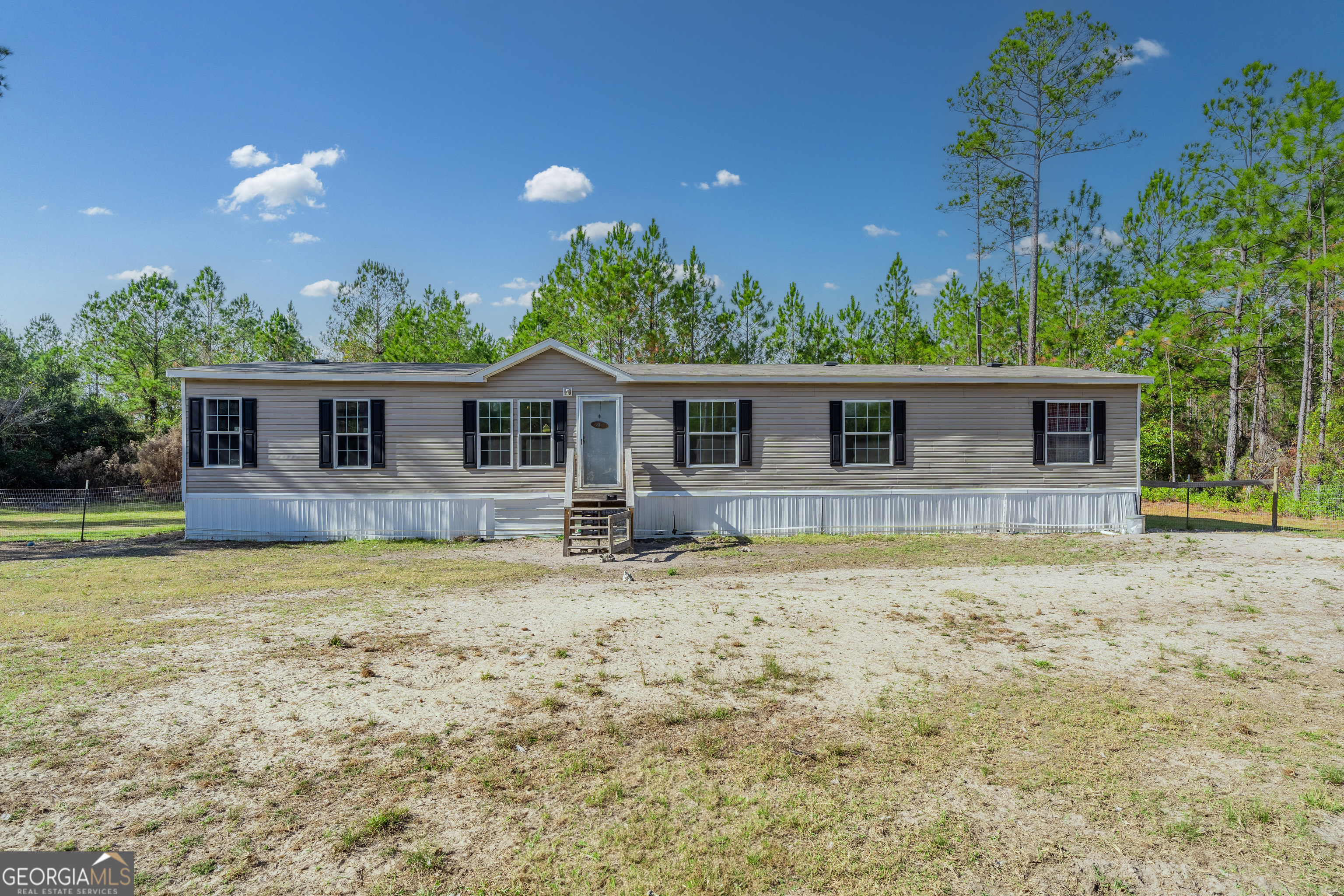 6911 Old Hortense Road Hortense, GA 31543 - Photo 17 of 19 front view of a house with a yard