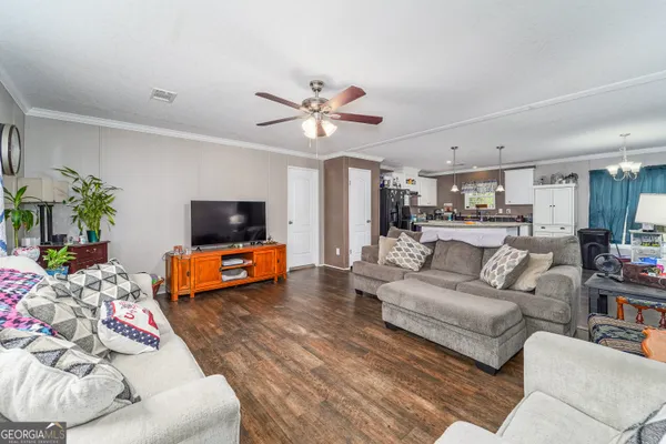 a living room with furniture and a flat screen tv