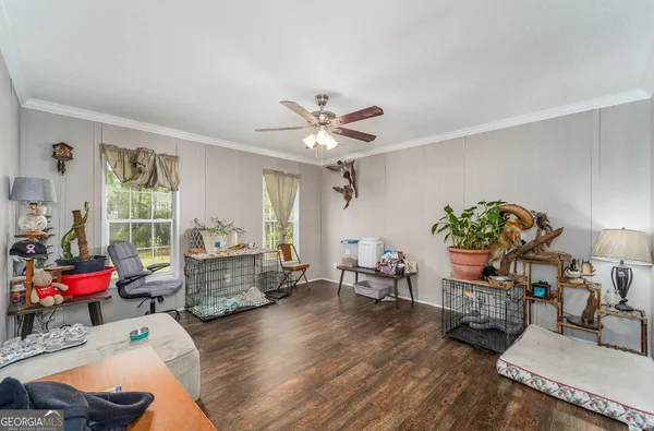 a living room with furniture and wooden floor