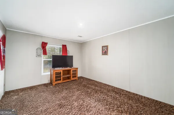 a view of a livingroom with furniture and cabinet