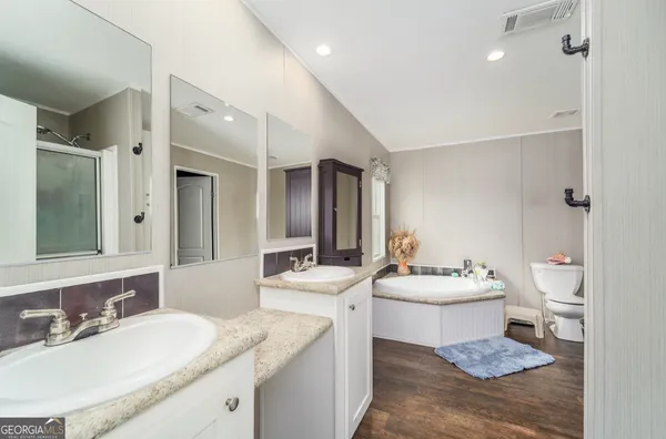 a bathroom with a sink toilet and a mirror