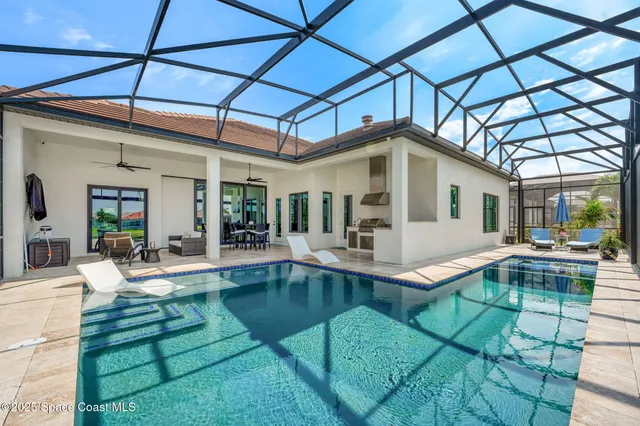 a view of a house with swimming pool and sitting area