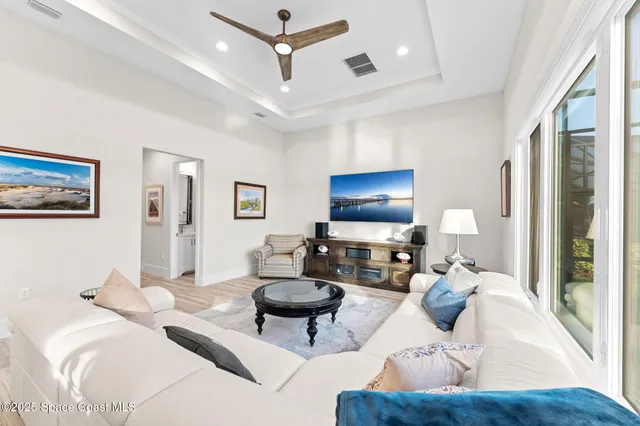 a spacious bedroom with a bed and wooden floor