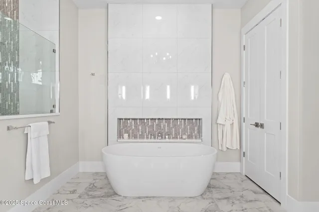 a dining room with furniture and a floor to ceiling window