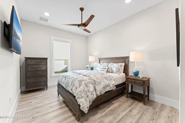 a view of a ocean with a floor to ceiling window chair and table