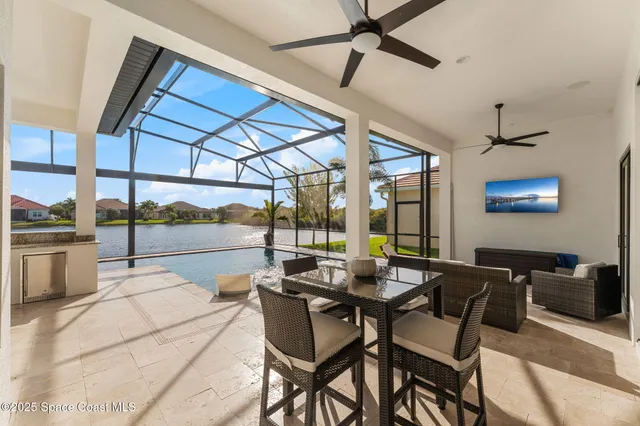 an aerial view of residential houses with outdoor space and parking