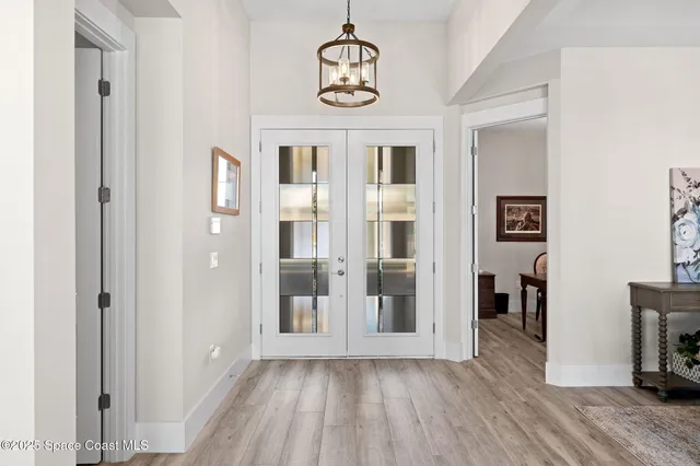 a view of a dining room with furniture and chandelier