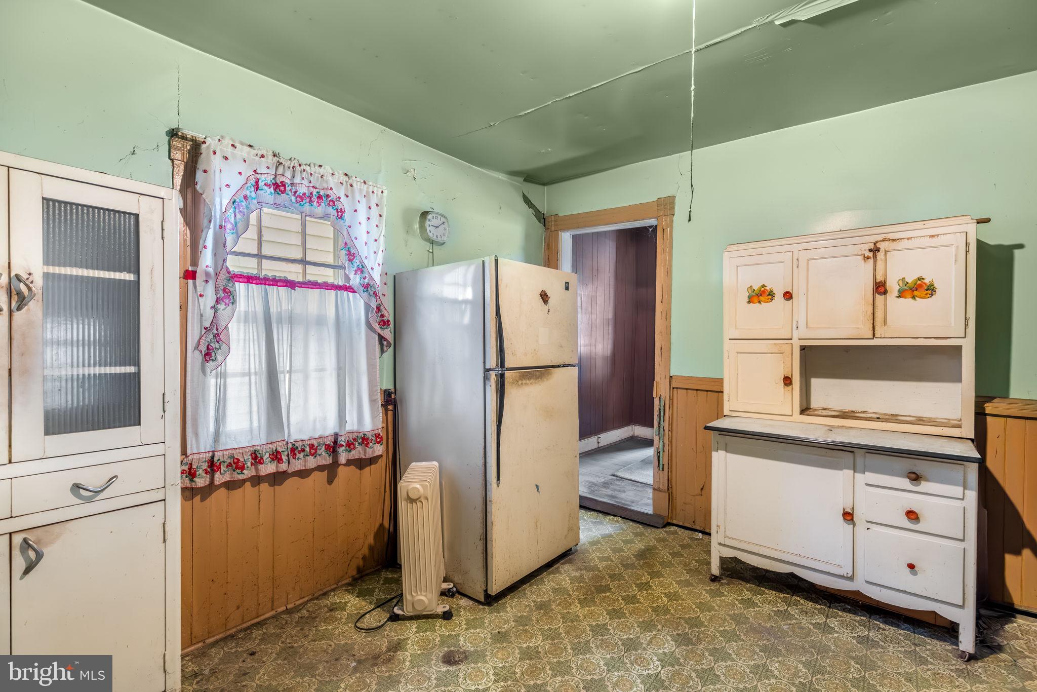 169 East Main Street Orange, VA 22960 - Photo 11 of 27 a kitchen with cabinets and refrigerator