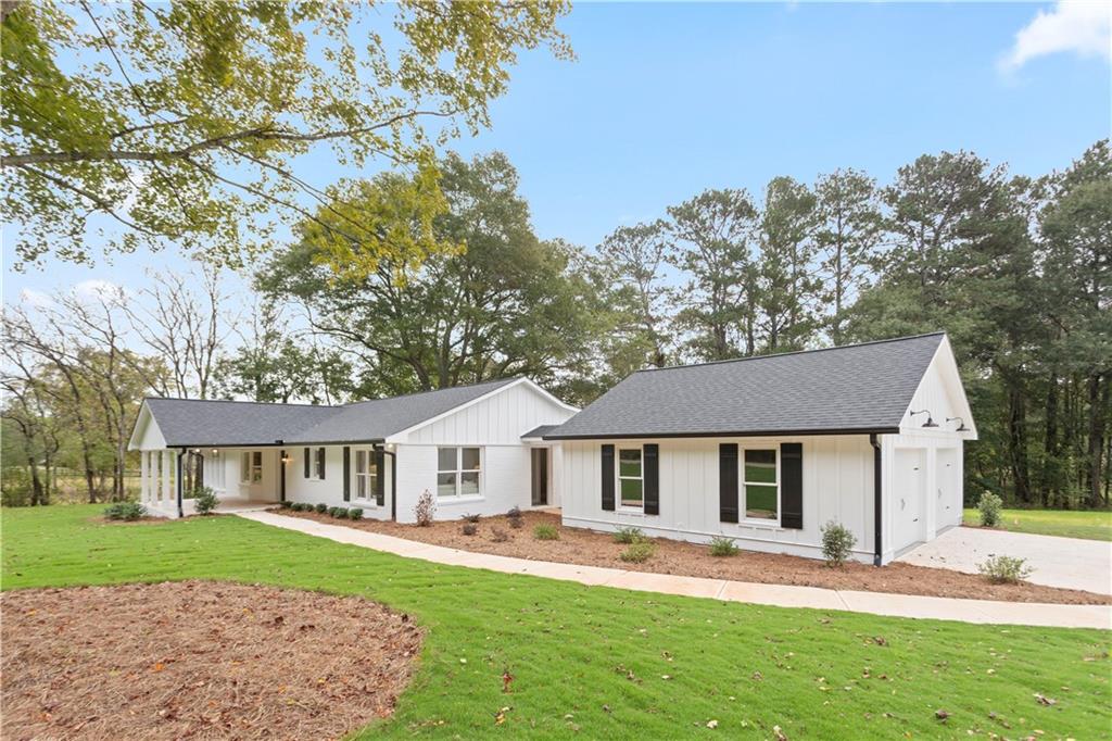 2536 Lower Union Hill Road Canton, GA 30115 - Photo 1 of 1 a front view of a house with a garden and trees