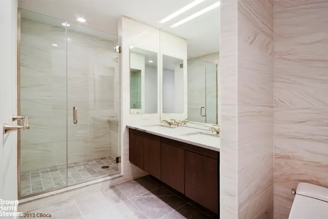 a kitchen with stainless steel appliances granite countertop a sink a refrigerator and a stove