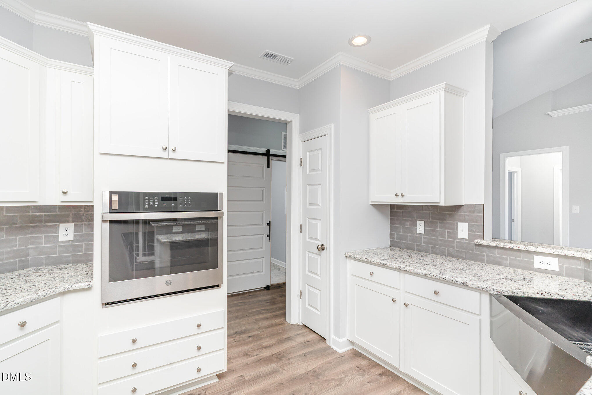 88 Bodacious Lane Benson, NC 27504 - Photo 12 of 32 a kitchen with stainless steel appliances white cabinets and a counter top space