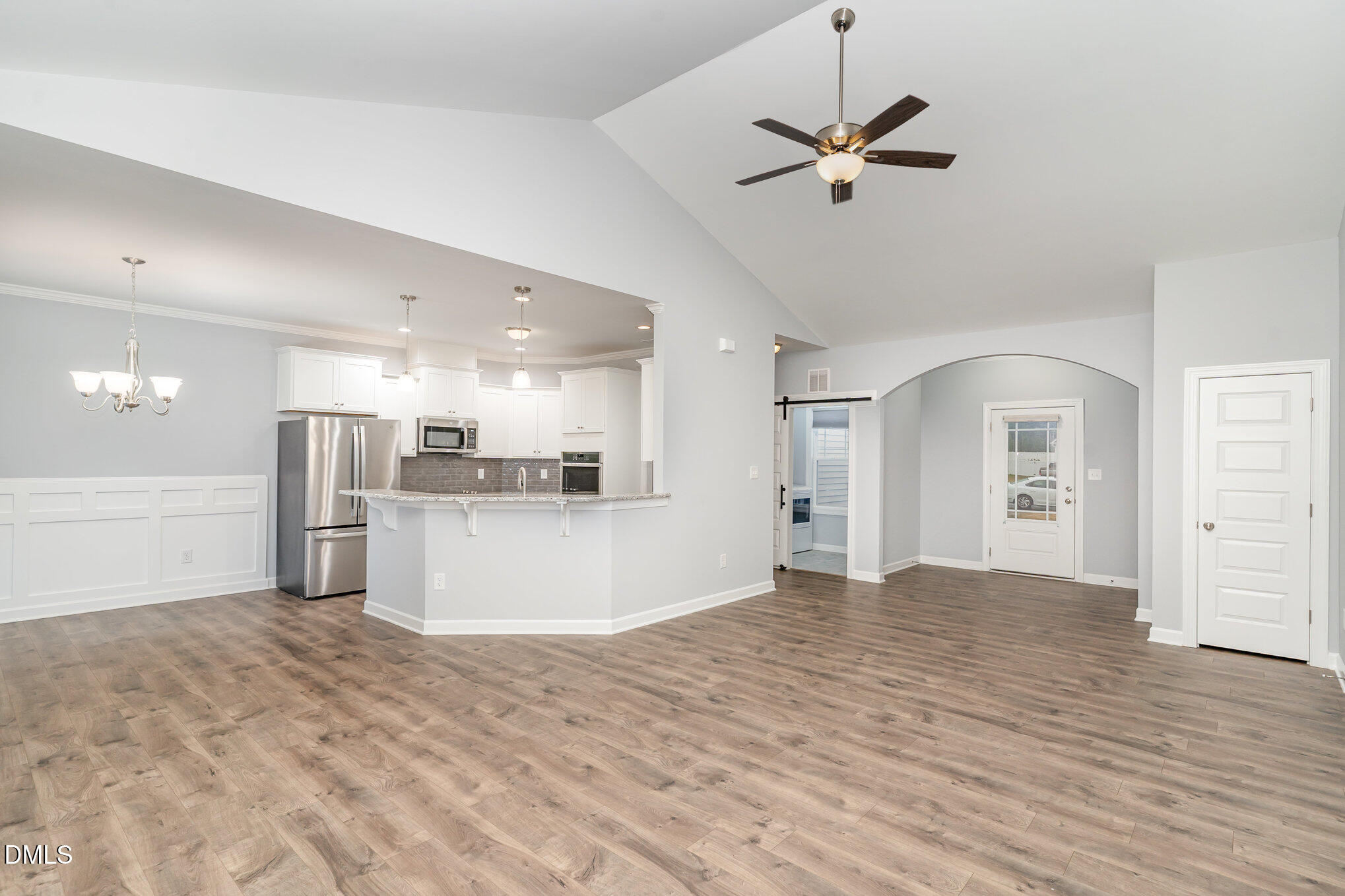 88 Bodacious Lane Benson, NC 27504 - Photo 9 of 32 a view of a livingroom with a kitchen stove a refrigerator with a ceiling fan