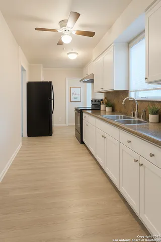 a kitchen with a cabinets and chandelier