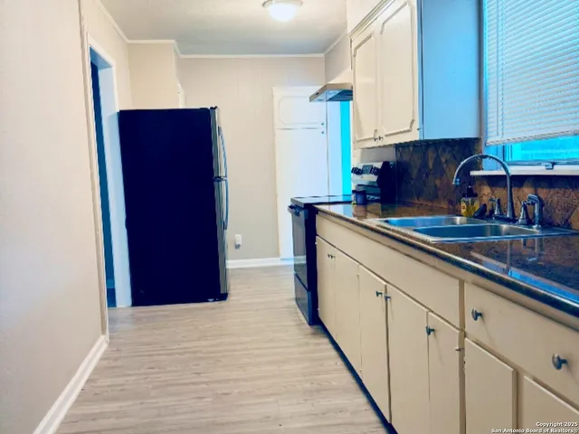 a kitchen with stainless steel appliances granite countertop a refrigerator and a sink