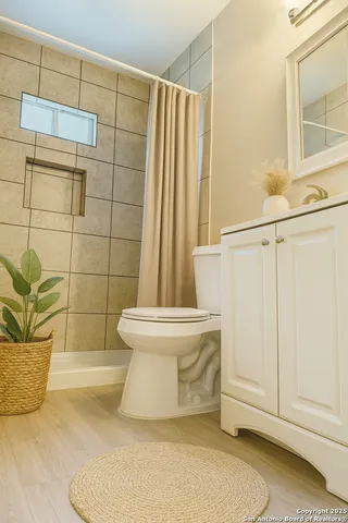 a bathroom with a toilet and a shower