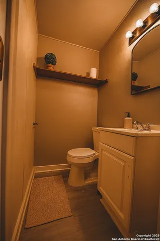 a bathroom with a toilet and a mirror