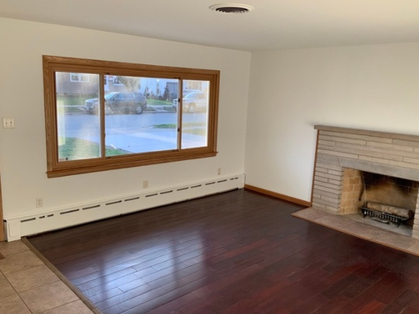 1100 Frederick Street Joliet, IL 60435 - Photo 3 of 10 an empty room with wooden floor and windows