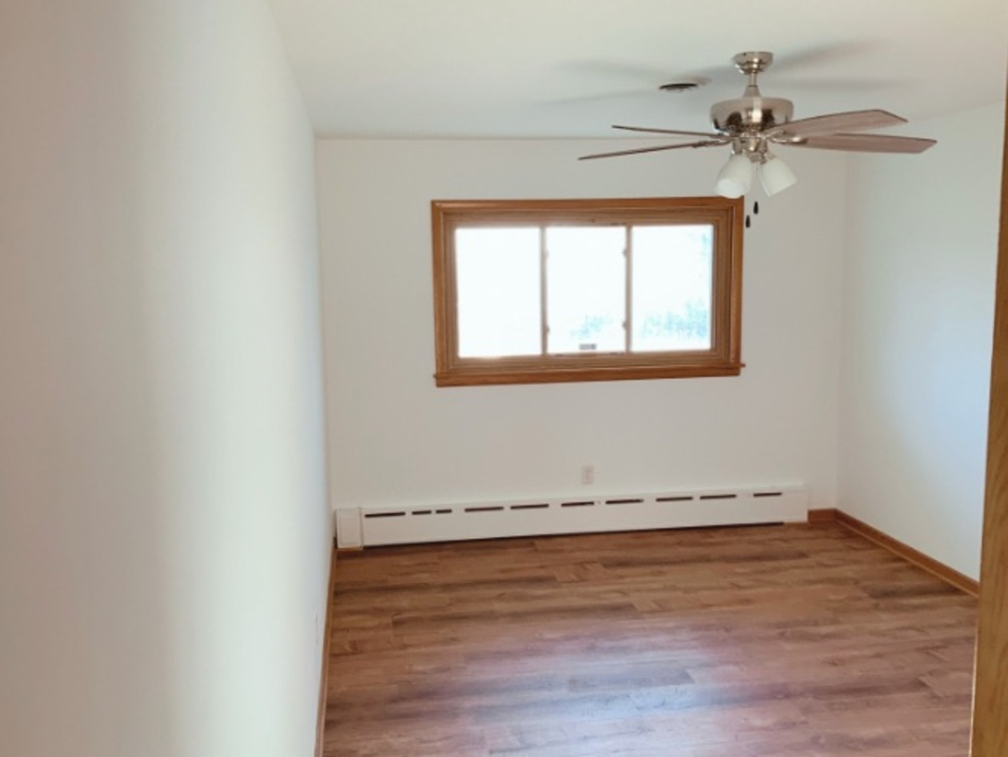 1100 Frederick Street Joliet, IL 60435 - Photo 5 of 10 an empty room with wooden floor chandelier fan and windows