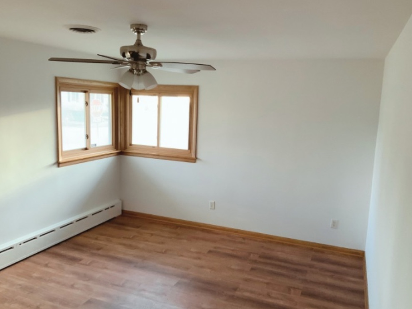 1100 Frederick Street Joliet, IL 60435 - Photo 6 of 10 a view of empty room with wooden floor and fan
