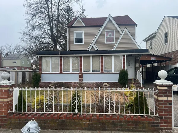 a front view of house with a yard and balcony