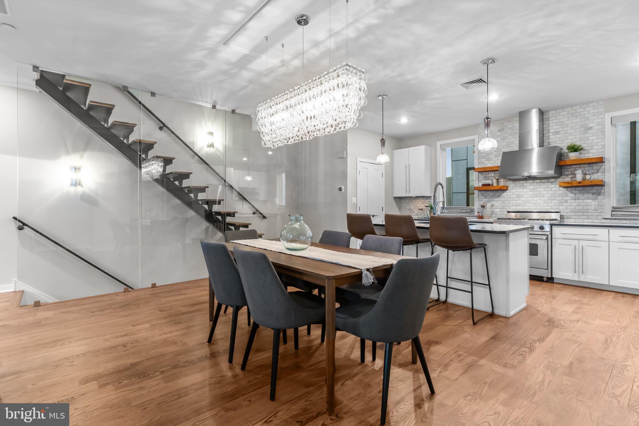 412 Moyer Street, Unit 7 Philadelphia, PA 19125 - Photo 14 of 55 a dining hall with stainless steel appliances kitchen island a table and chairs