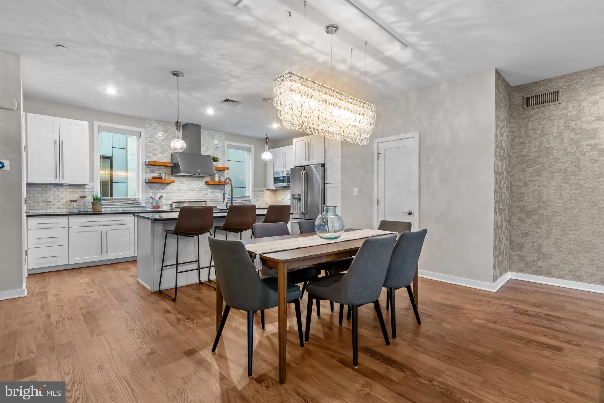 412 Moyer Street, Unit 7 Philadelphia, PA 19125 - Photo 15 of 55 a kitchen with a dining table chairs and wooden floor
