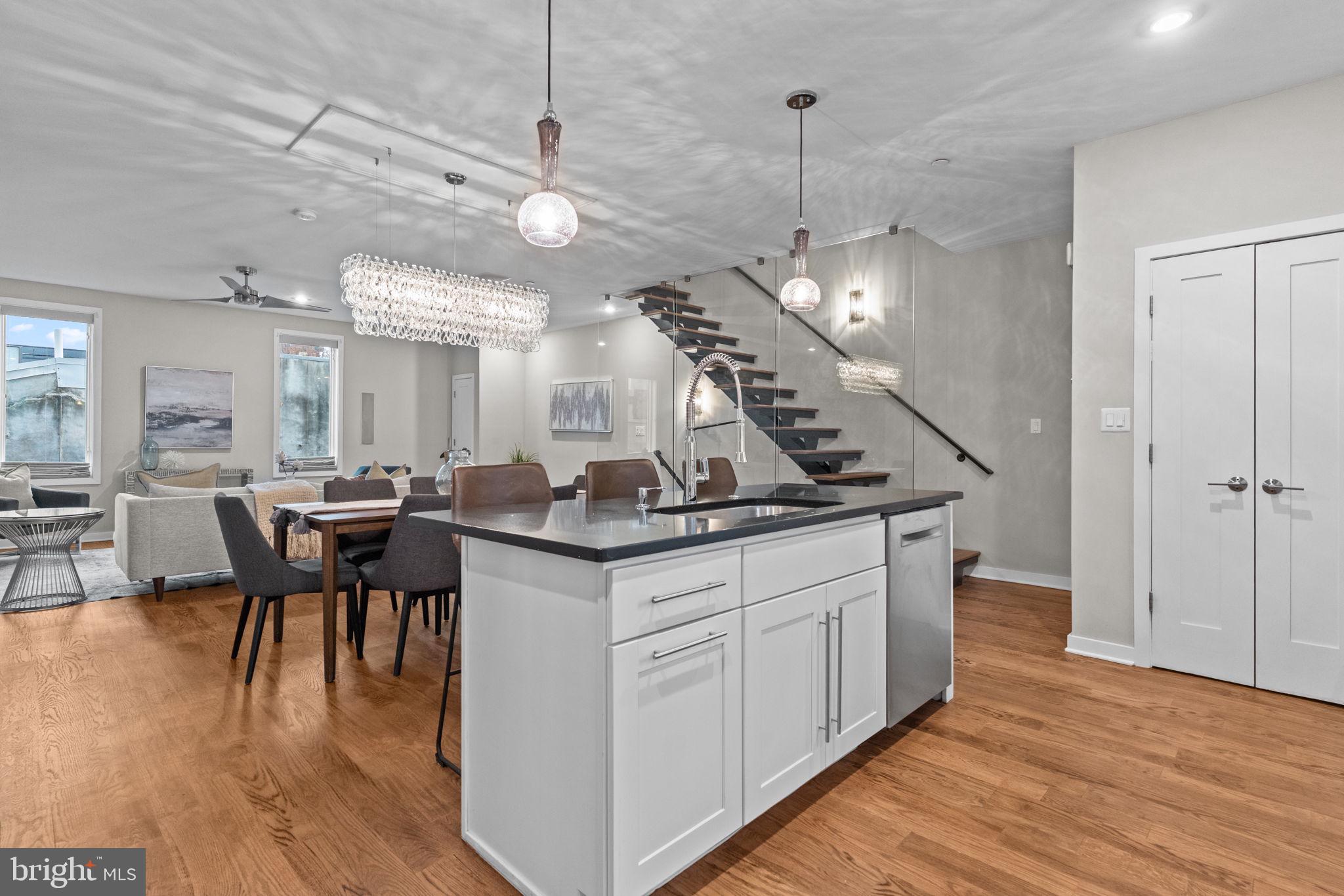 412 Moyer Street, Unit 7 Philadelphia, PA 19125 - Photo 20 of 55 a kitchen with center island white cabinets and wooden floors