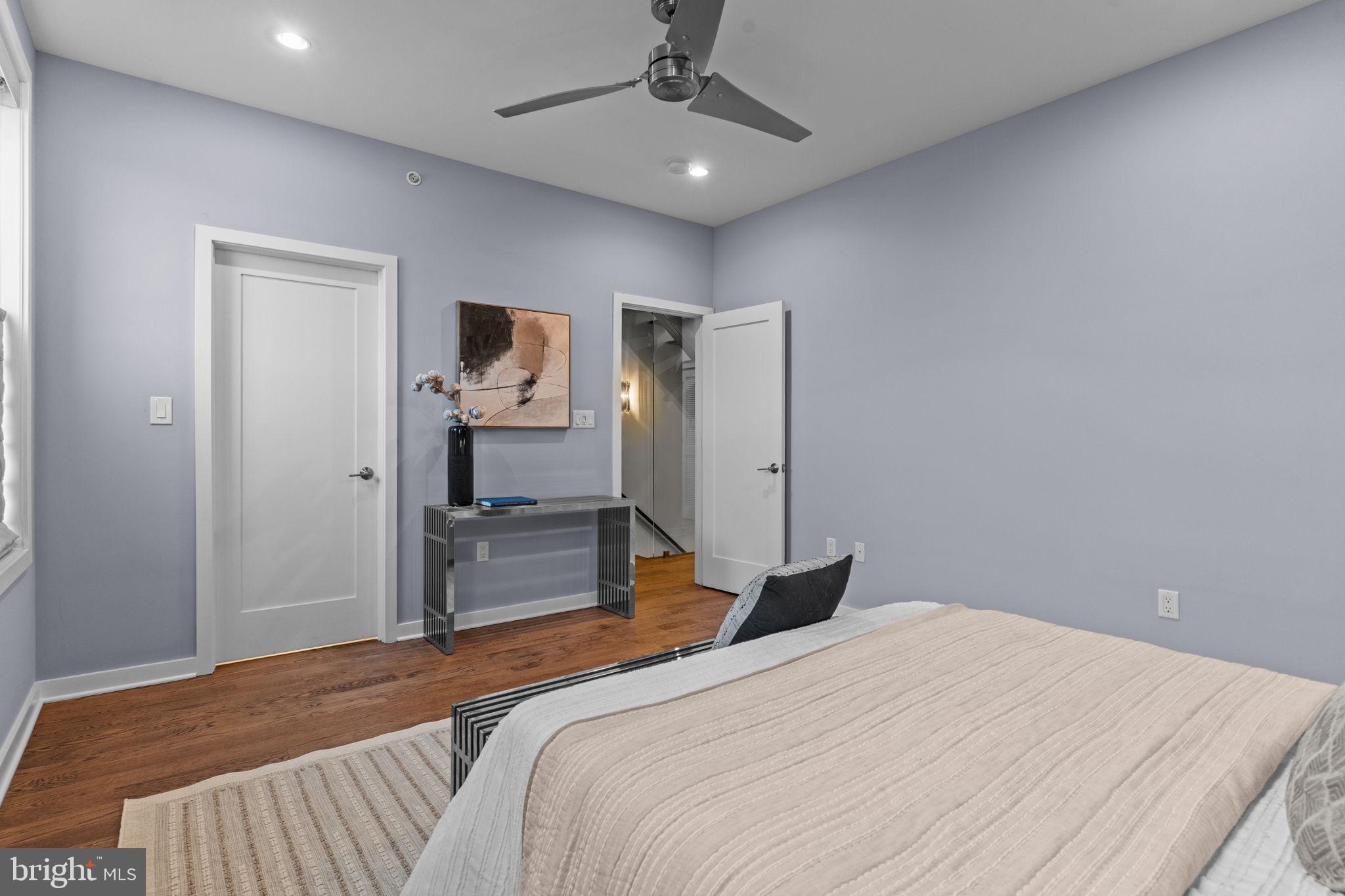 412 Moyer Street, Unit 7 Philadelphia, PA 19125 - Photo 25 of 55 a bedroom with a bed and a chandelier