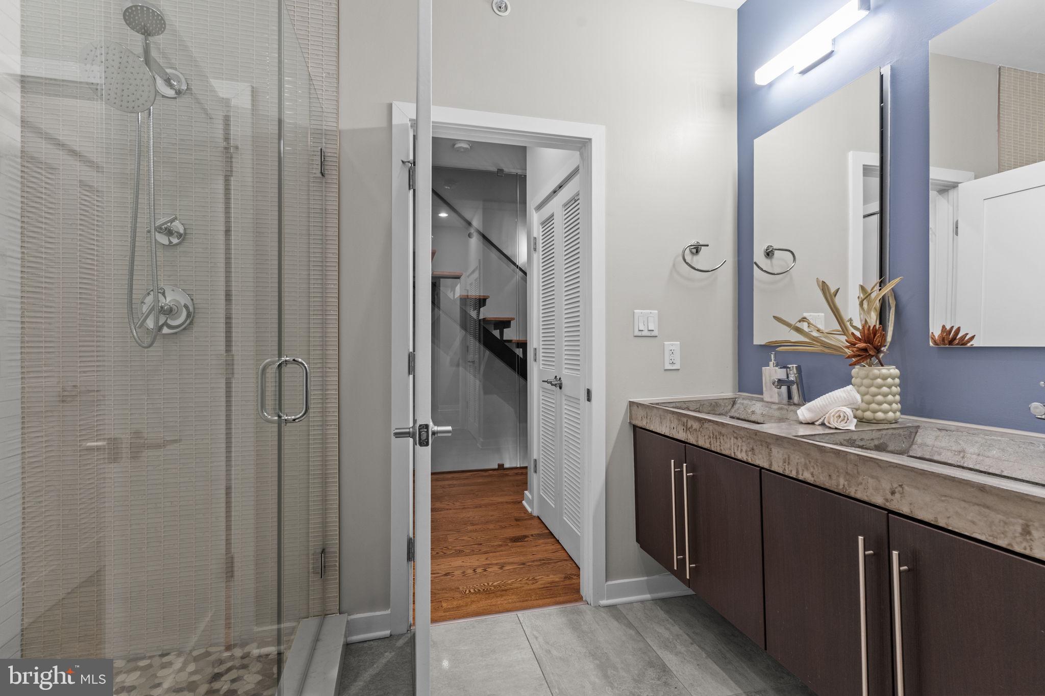 412 Moyer Street, Unit 7 Philadelphia, PA 19125 - Photo 29 of 55 a bathroom with a granite countertop shower sink and mirror