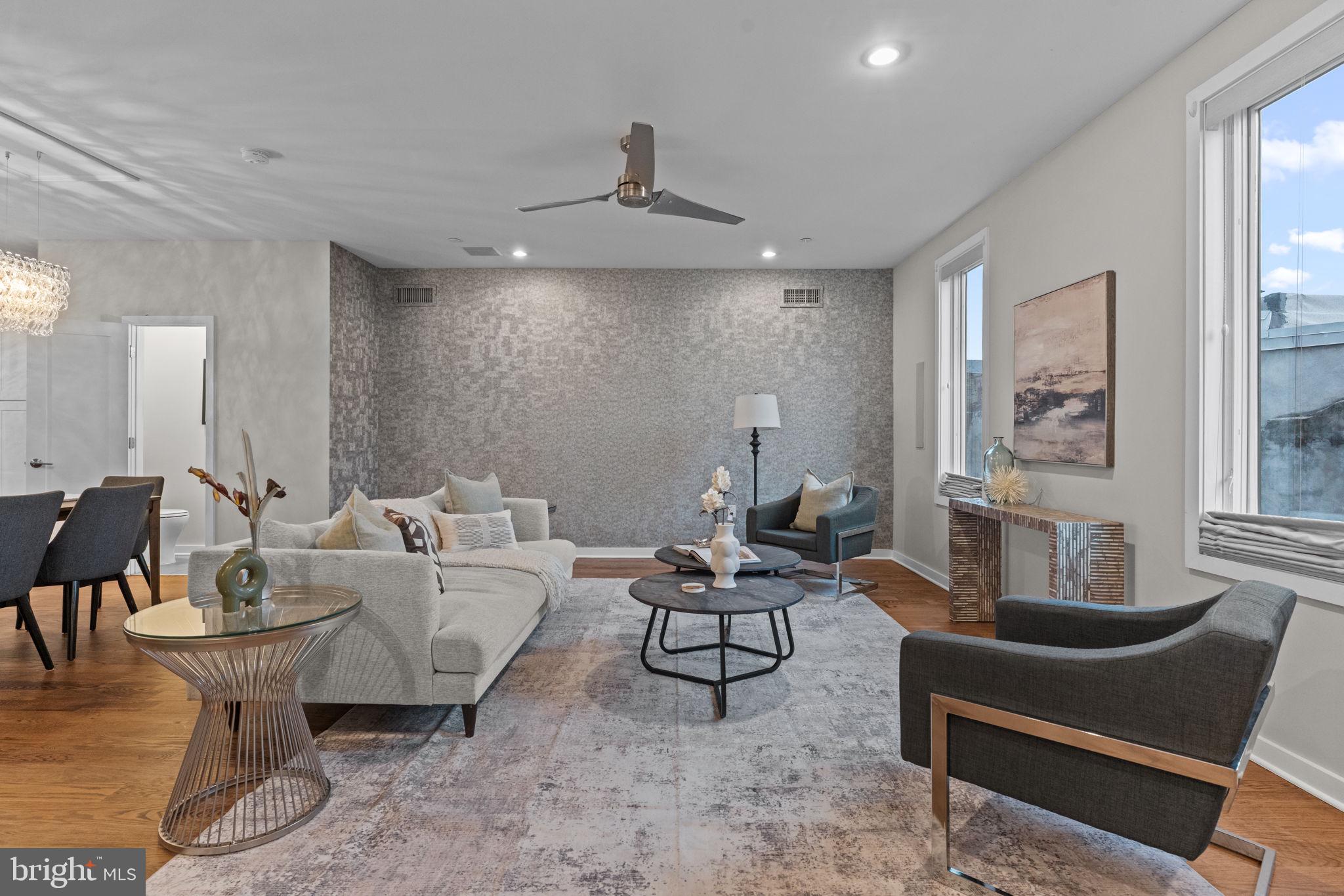 412 Moyer Street, Unit 7 Philadelphia, PA 19125 - Photo 38 of 55 a living room with furniture a rug and a chandelier
