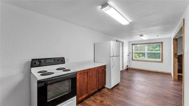 a kitchen with stainless steel appliances a stove a microwave and a refrigerator