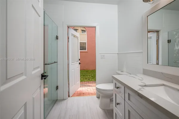 an entryway of a house with wooden floor