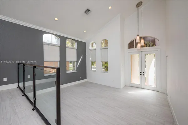 a view of a room with gym equipment and windows