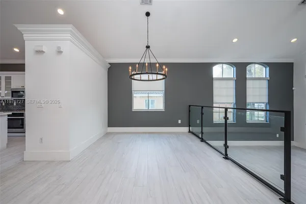 a view of a kitchen with refrigerator and windows