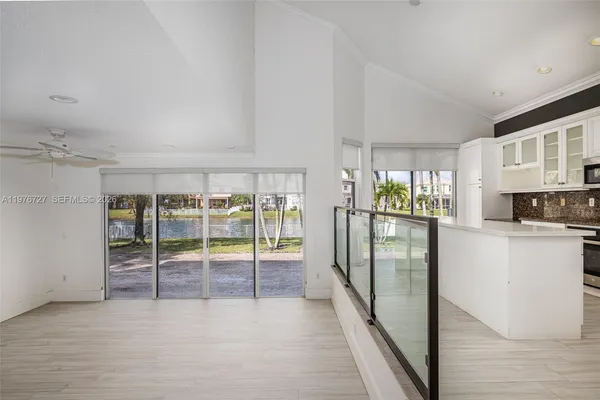 a kitchen with stainless steel appliances kitchen island granite countertop a refrigerator and a stove top oven
