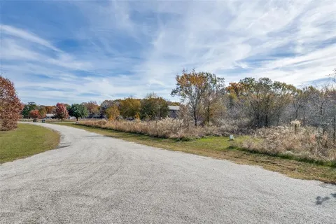 a view of a road with a yard