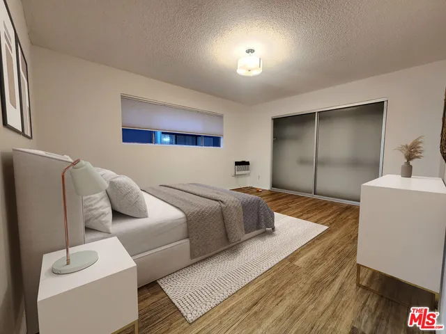 a bedroom with furniture and a wooden floor