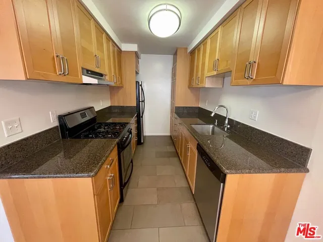 a kitchen with granite countertop cabinets and sink