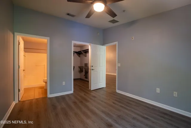 an empty room with wooden floor and closet
