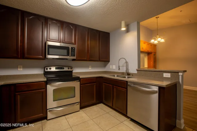 a kitchen with sink a microwave and stove